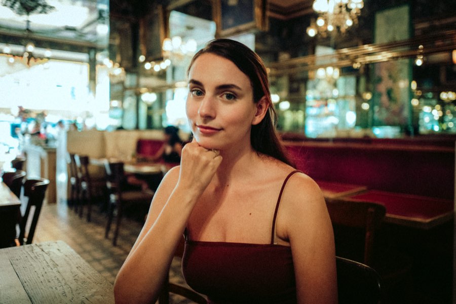 Woman resting her chin on her hand in an elegant café