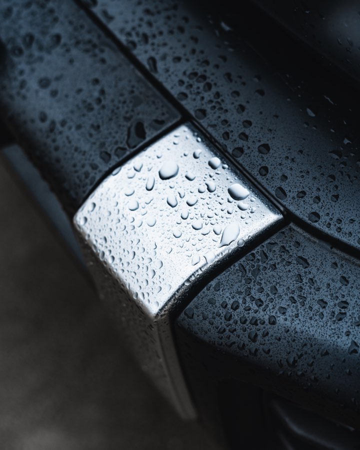 Raindrops on a chrome detail of a black Mercedes G 63