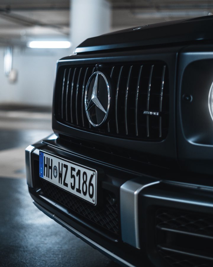 Front grille of a black Mercedes G 63 in an underground car park