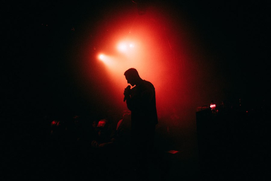 Silhouette of Navy on stage in red light