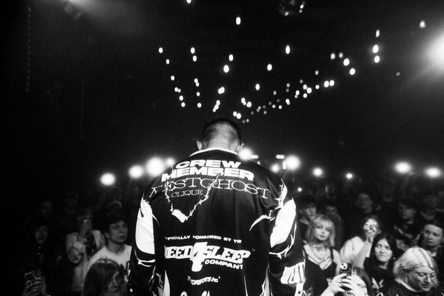 Black and white photo of Navy from behind, facing the crowd