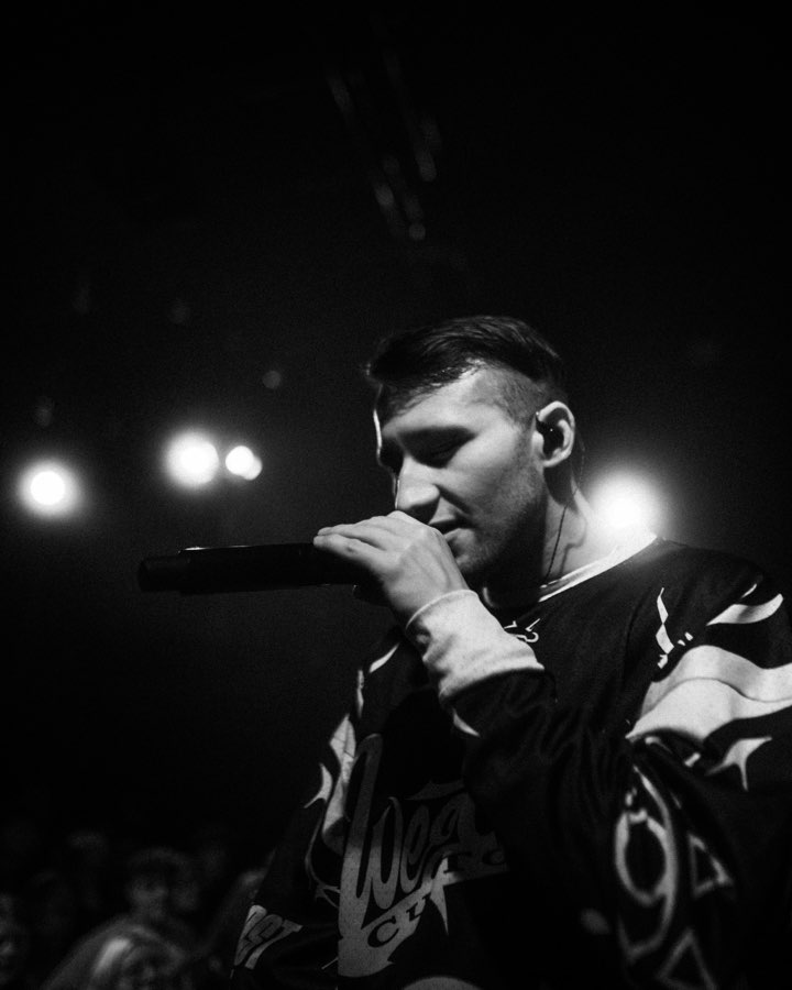 Black and white close-up of Navy rapping into the microphone